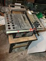 Full view of Durex table saw on wood base with casters