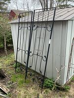 Full view of both trellis panels leaning against shed