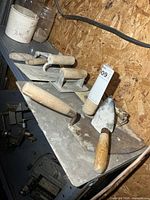 Shelf with all four trowels visible; shows overall lot