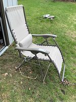 Zero-gravity chair side view showing beige sling and grey frame