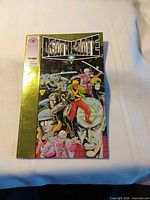 Front cover of Deathmate Yellow comic showing title, artwork, gold foil border