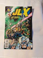 Full front cover of JLX #1 showing title, characters, and publisher logo