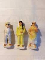 Front view of three glazed figurines