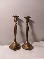 Both brass candlesticks front view showing overall design and condition