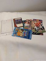 All items laid out: hard case, Webkinz pack, Catwoman card, stack of NFL cards