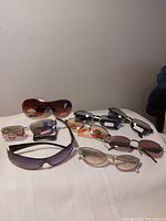 Group shot of all eight sunglasses styles on surface