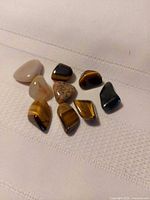 Nine polished gemstones laid out on cloth