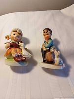 Both figurines front view on white cloth