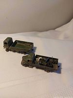 Two army wagons side by side, showing overall condition and soldiers in one bed