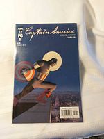 Front cover of Captain America #12 comic in sleeve