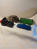 Group shot of four colored Avon car bottles