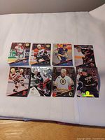 Nine hockey cards laid out 3×3 on table