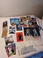 Overview of all cards, Maple Leafs photos, ticket stubs laid on white surface