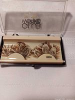 Front view of eyelashes in tray inside clear case showing branding and model number 0030