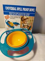 Front of boxed Universal Spill Proof Bowl and bowl nested inside outer ring