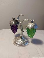 Salt and pepper shakers hanging on metal tree stand