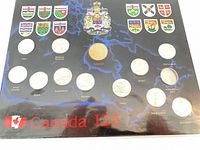 Front view of Canada 125 coin set showing all coins and printed shields