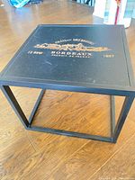full view of square side table showing metal frame and top