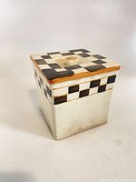 Large canister with lid showing checkerboard pattern and tan trim