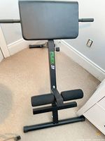 Top view of Flex It hyperextension bench showing vinyl pad, side handles, foam rollers and steel base