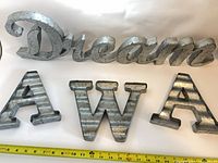 All four galvanized wall pieces with tape measure for scale