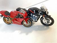Both model motorcycles side by side showing overall condition