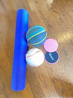 All four items: foam roller, basketball, soccer ball, two gliding discs