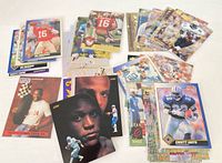 Spread of approximately 30 NFL trading cards showing various star players and brands