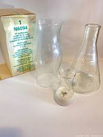 Hurricane globe, both flasks, and Partylite box grouped together