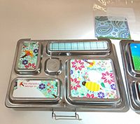 Lunchbox showing floral, bird and plaid magnets installed