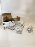 All four printed glasses with open box