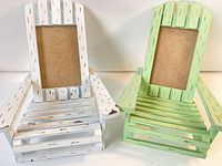Front view of white and green Adirondack chair frames