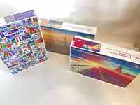 Front view of three puzzle boxes showing titles and images