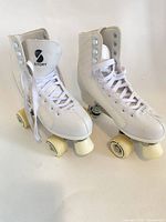 Both white Story Phoenix quad roller skates front view