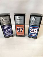 Front view of three boxed Tim Hortons NHL Superstar mini sticks for McDavid, Marner and MacKinnon