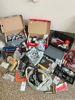 Overall view of lot showing drill, tools, fasteners, jumper cables and boxes