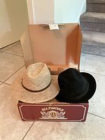 Both hats resting in Biltmore box
