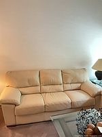 Front view of beige/cream three-seat sofa