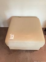 Top view showing square beige ottoman surface