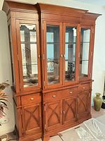 Full view of china cabinet showing upper glass display section and lower storage