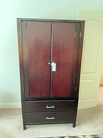 front view of closed armoire showing drawers and doors