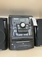 front view of Encore Technology 9409MO stereo main unit between speakers