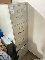 Full view of the 4-drawer metal filing cabinet showing all drawers and lock