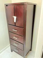 Full view of tall chest showing cabinet doors and four drawers