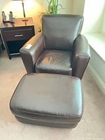 Front view of Natuzzi armchair with ottoman