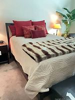 Full view of bed frame, mattress, bedding and throw