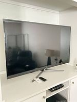Front view of Samsung 55" smart TV on stand