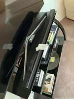 Soundbars stacked on media console with remote visible