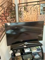 Front view of Samsung curved 55-inch TV on stand