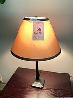 Full view of one lamp with shade on tabletop